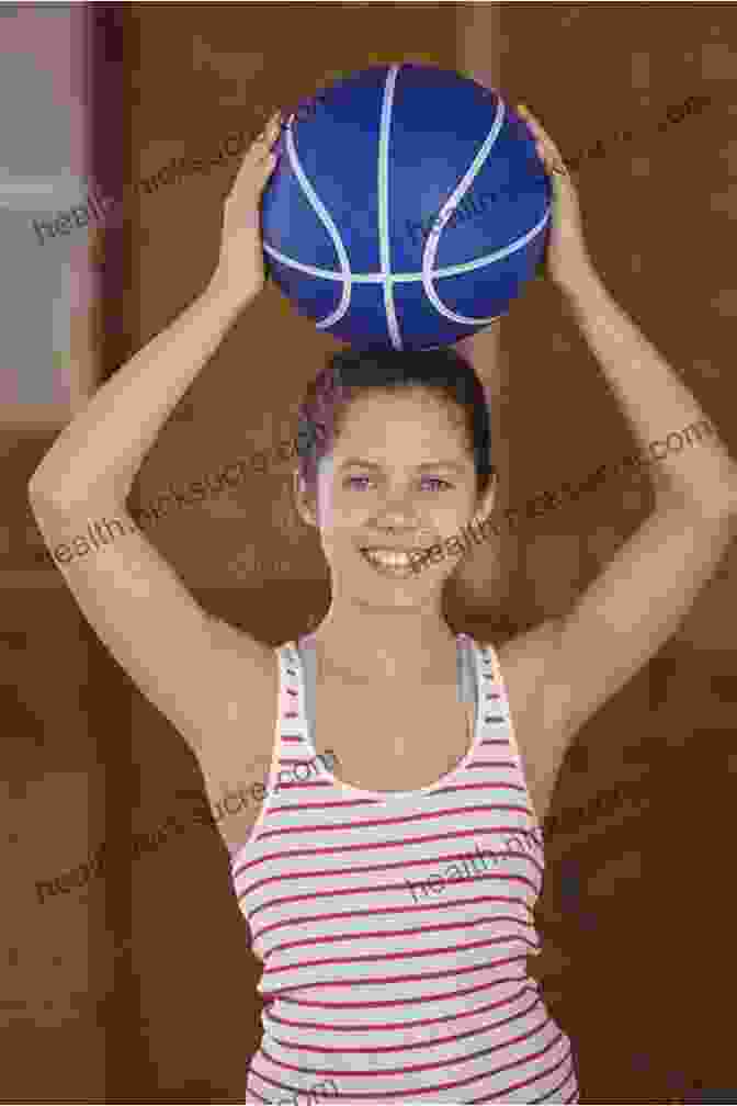 A Smiling Young Girl With One Arm Holding A Basketball, Displaying Determination In Her Eyes. The One Winged Phoenix: A True Story Of A Young Girl With One Arm And A Fighting Spirit